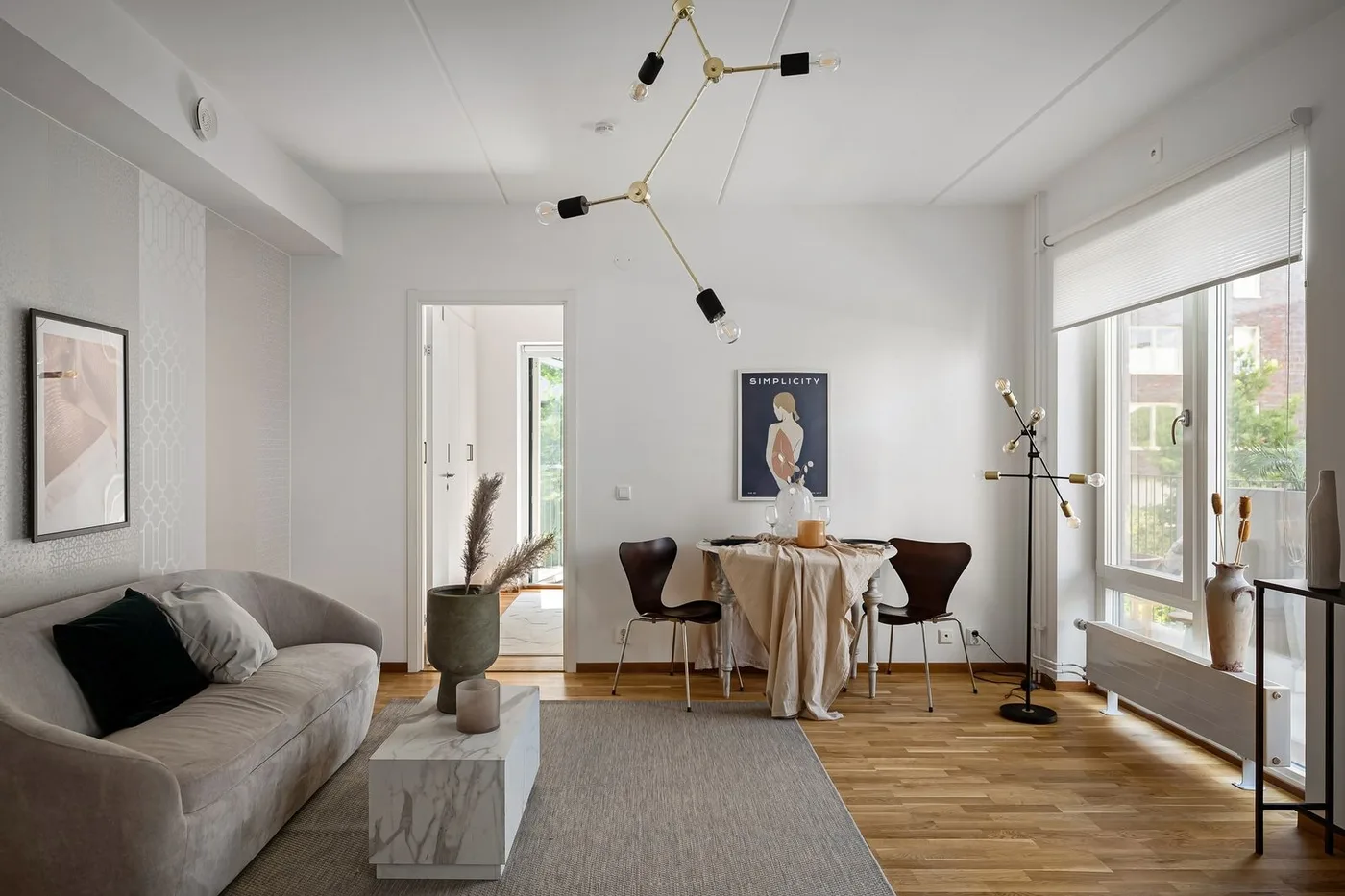 A clean, bright living room with sofas, a low table and plants